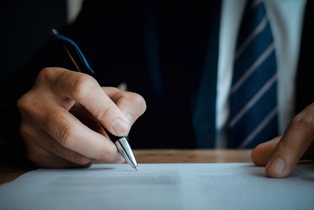 Close,Up,Business,Man,Reaching,Out,Sheet,With,Contract,Agreement