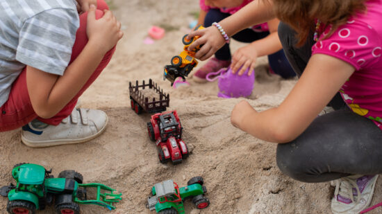 Group,Of,Kids,Playing,Outdor,In,Sand,With,Plastic,Toys