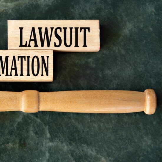 Defamation,Lawsuit,-,Words,On,Wooden,Blocks,On,A,Green