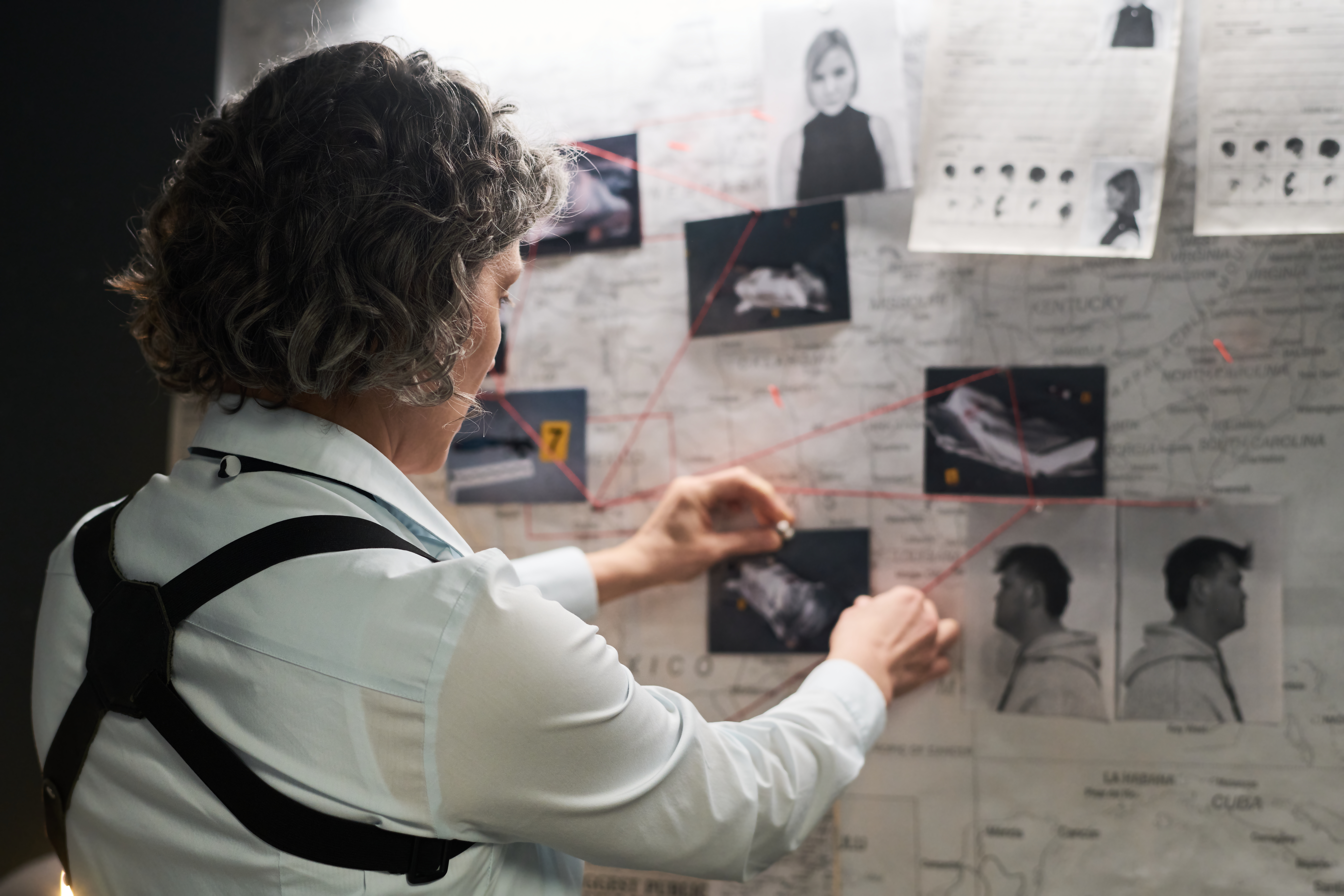 Focused,On,Mapping,Out,Possible,Suspects,And,Connections,With,Red