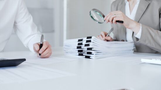 Auditors,And,Financial,Experts,Analyzing,Tax,Documents,,Reviewing,Contract,Papers,